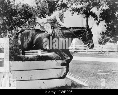 First Lady Jacqueline Kennedy, riding her horse Ninbrano, clears a hurdle at the Loudoun Hunt horse show in Leesburg, Va. May Stock Photo