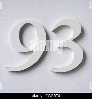 three dimensional house number ninety three white lettering on a white wall Stock Photo