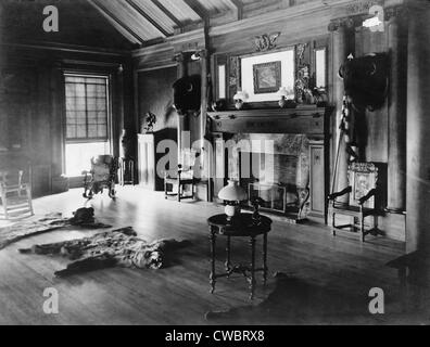 Trophy room at Sagamore Hill, summer home of President Theodore Roosevelt, with bison heads and a bearskin rug in front of a Stock Photo