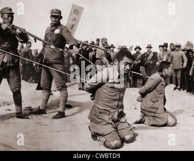 Two Chinese men kneeling prior to execution by Chinese soldiers. The Sino-Japanese war (1937-1945) was a fight against the Stock Photo