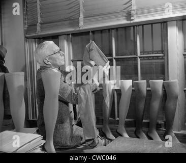 Agriculture Department fabric technician examines the cotton stockings that would replace those made by Japanese silk, after Stock Photo