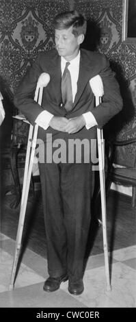 President John F. Kennedy (1917-1963), standing with crutches on June 12, 1961.
