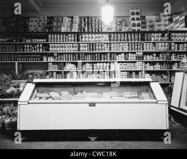 Refrigerator for perishable meat and vegetables in a Washington, D.C. Grocery store, in the 1920s. The shelves are lined with Stock Photo