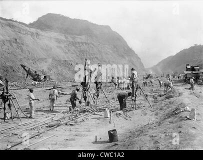 Panama Canal construction showing workers drilling holes for dynamite in bedrock, as they cut through the mountains of the Stock Photo