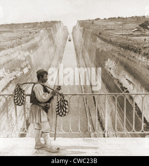 Greek man in traditional costume on a bridge over the Corinth Canal built between 1881 and 1893. Cut through sedimentary rock Stock Photo