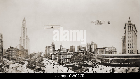 Wide angle panorama with two airplanes in flight over downtown Manhattan. At left are the Custom House and Woolworth Building Stock Photo