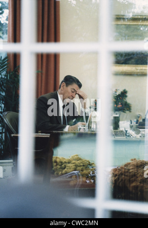 President Reagan working at his Oval Office desk shortly before ...