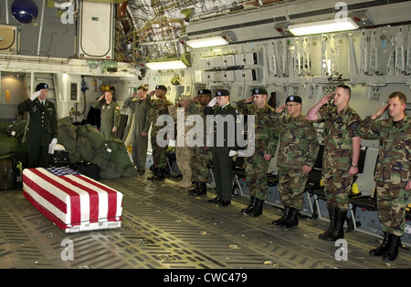 U.S. Military personnel salute the flag draped coffin Chief Petty Officer Matthew J. Bourgeois during his Fallen Soldier Stock Photo