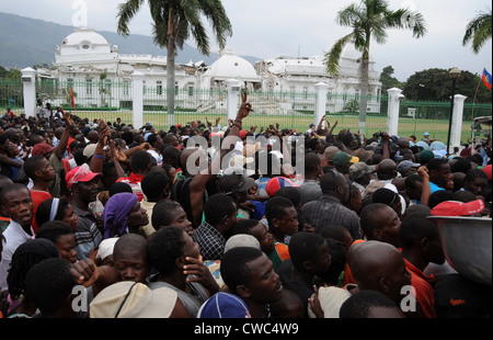 Haitians gathers for food distribution in front of the destroyed Presidential Palace in Port au Prince Haiti on Jan. 25 2010. A Stock Photo