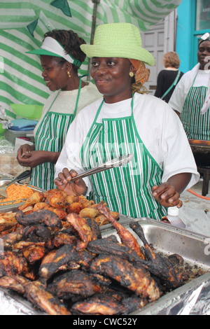 Woman selling Jerk Chicken at Notting Hill Carnival London Stock Photo