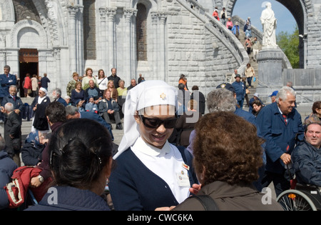 Pilgrims in front of the Basilica of the Immaculate Conception in Lourdes, France Stock Photo