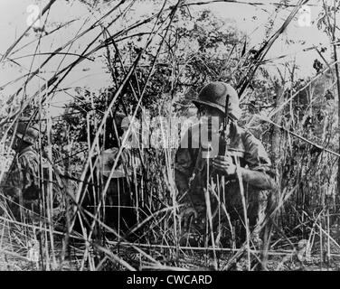 French Foreign Legionnaires in Vietnam. French soldiers on patrol crouched in thicket outside Dien Bien Phu, Vietnam. 1954. Stock Photo