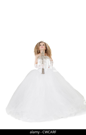 Bride girl in wedding gown holding crucifix looking up over white background Stock Photo
