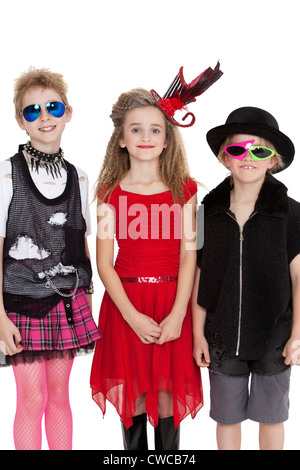 Portrait of school children wearing fancy dress outfits over white background Stock Photo