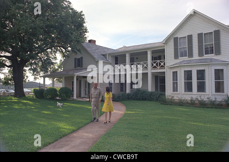 President Lyndon Johnson, Lady Bird, and their dog Yuki in front of their House on the LBJ Ranch. May 15, 1968. Stock Photo