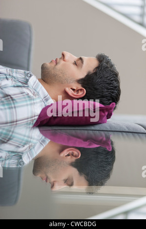 Man sleeping on a couch Stock Photo