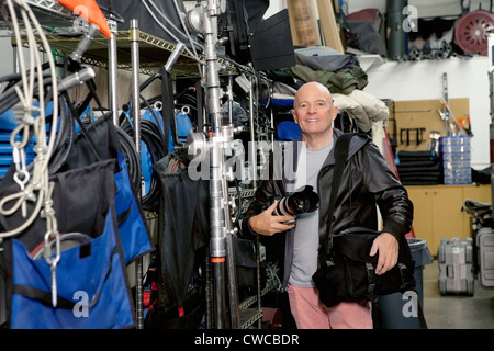 Portrait of a happy senior photographer in studio Stock Photo