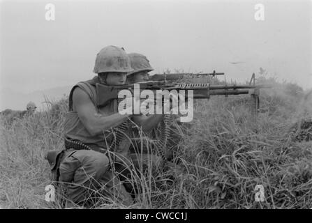 Vietnam War. US Marine machine gunner and rifleman fire at the enemy near the Demilitarized Zone in Vietnam. May 13, 1967. Stock Photo