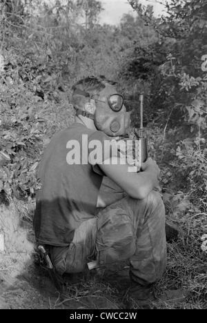 Vietnam War. US Marine wearing gas mask while waiting to enter a Viet Cong tunnel 22 miles south of DaNang, Vietnam. 1968.