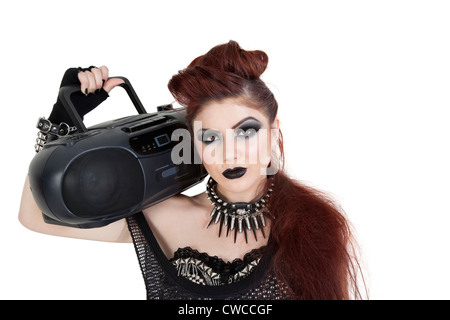 Portrait of punk woman holding boom box on shoulder over white background Stock Photo