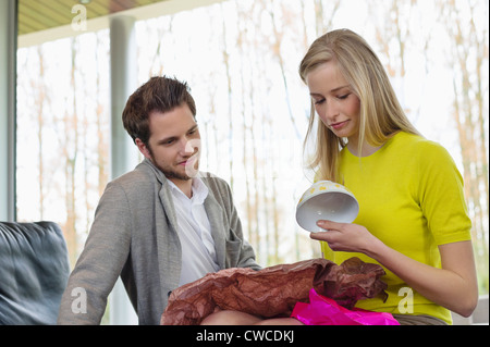 Happy woman looking at a present given by her boyfriend Stock Photo