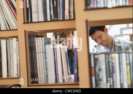 Couple choosing books from a bookshelf Stock Photo