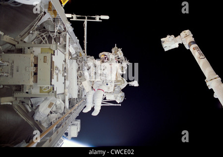 Construction work on International Space Station. Astronaut Michael Lopez-Alegria in a space walk near the Canadarm while