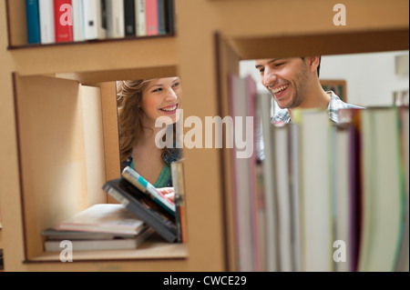 Couple choosing books from a bookshelf Stock Photo