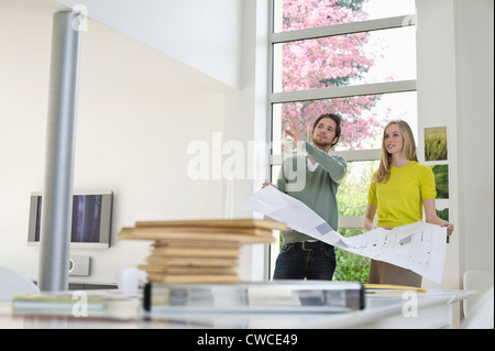 Interior designer discussing plan with a woman Stock Photo