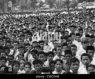 Indonesians in an  anti-Sukarno rally in Batu Sankar, Sumatra. They protested President Sukarno's consolidation of dictatorial Stock Photo