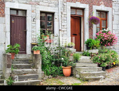 Houses with flowers along the place Saint-Georges / Saint George Square in the town Limbourg in the Belgian Ardennes, Belgium Stock Photo