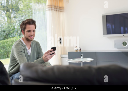 Man reading a text message on mobile phone Stock Photo