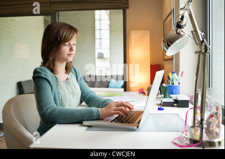 Girl using a laptop at home Stock Photo