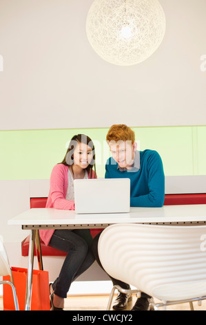 Business couple working on a laptop in an office Stock Photo