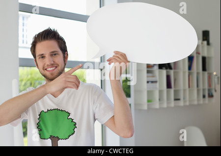 Man holding a speech bubble Stock Photo