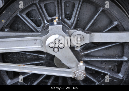 A steam locomotive wheel with the connecting rods show the power in ...