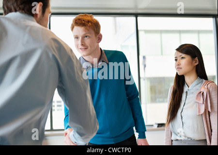 Business executive shaking hands with his clients Stock Photo