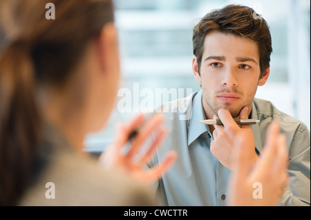 Business executive discussing with her client Stock Photo