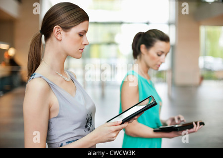 Businesswomen using digital tablets in an office Stock Photo