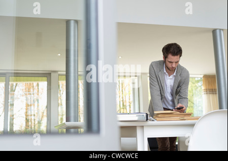 Interior designer using a mobile phone in the office Stock Photo