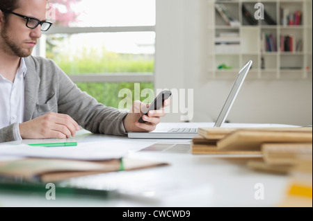 Interior designer using a mobile phone in the office Stock Photo