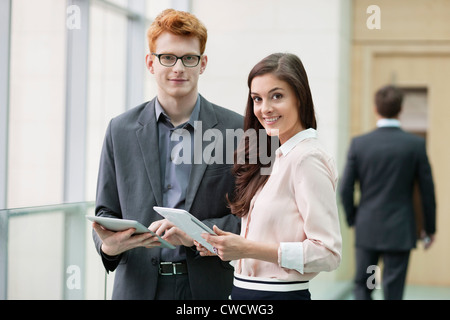 Portrait of business executives using digital tablets in an office Stock Photo