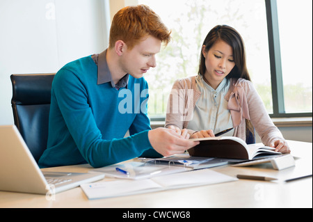 Businessman examining documents with his secretary Stock Photo
