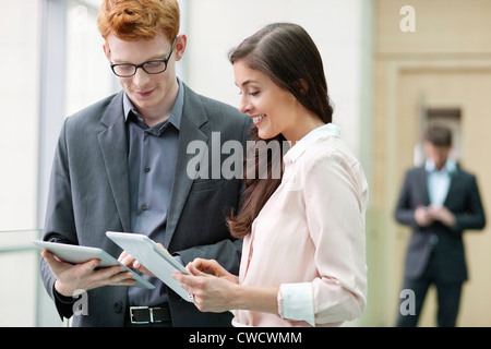 Business executives using digital tablets in an office Stock Photo