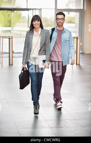 Business executives entering in an office lobby Stock Photo