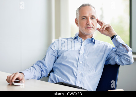 Businessman sitting in an office Stock Photo