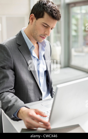Businessman working on a laptop in an office Stock Photo