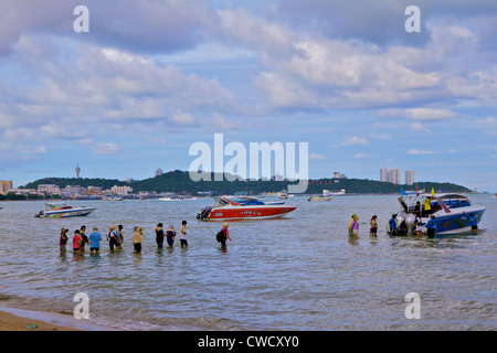 Tourists line up to board a boat in Pattaya, Thailand Stock Photo