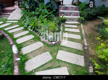 Stone paved footpath through garden. Stock Photo