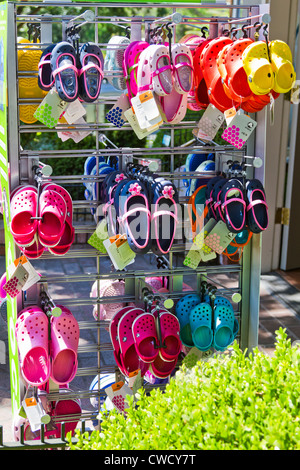 Colorful shoes are displayed for sale on the sidewalk in front of a shop in 'Los Gatos' California. Stock Photo